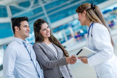 Doctor handshaking with a couple at the hospital-4