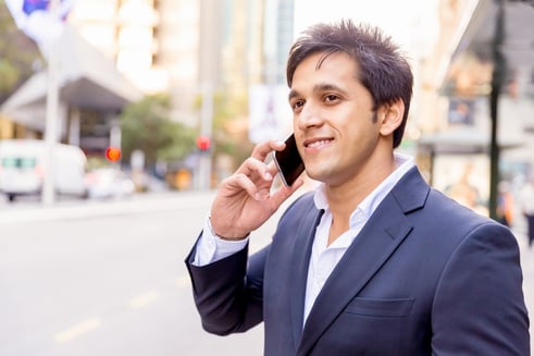 Portrait of confident businessman with his mobile phone outdoors.jpeg